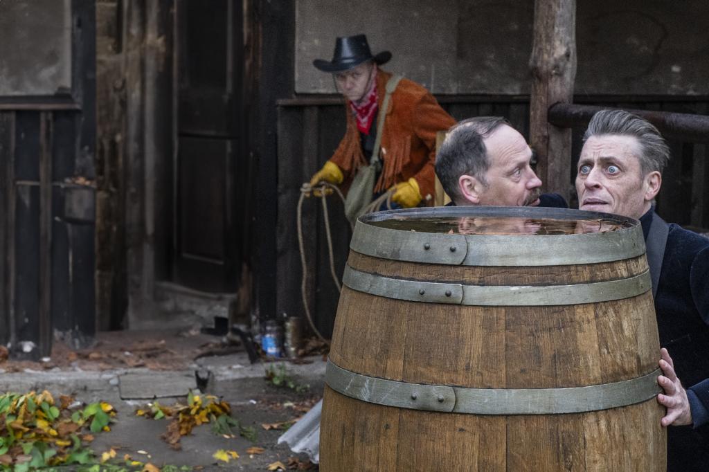 Two guys being captured by a cowboy with a lasso